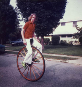 Kit Summers riding a unicycle with a very large wheel