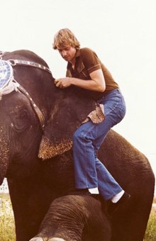 Kit Summers climbing on an elephant